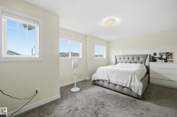 Multiple windows offering ample light, light-colored walls, and a flush-mount ceiling light fixture - 