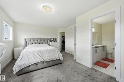Expansive room with neutral walls, light gray carpeting, and a window providing natural light - 