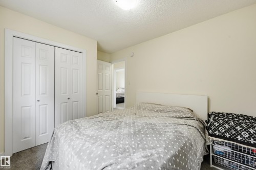 Light-colored walls, white trim, and bi-fold closet doors - 941 Ebbers Crescent Nw, Edmonton, AB 