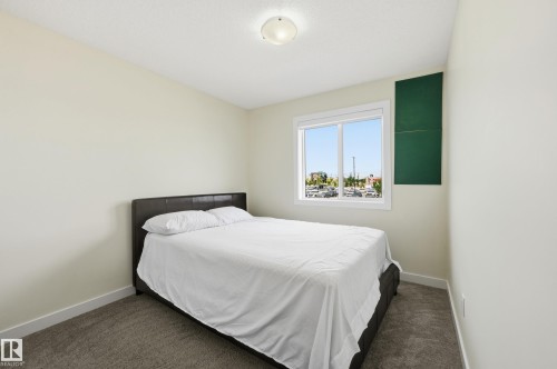 Carpeted room with a double-paned window, neutral wall paint, and a flush-mount ceiling light - 941 Ebbers Crescent Nw, Edmonton, AB 