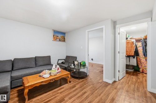 Wood-finish flooring throughout, white walls, and white trim - 941 Ebbers Crescent Nw, Edmonton, AB 
