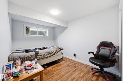 Wood-finish flooring, white walls, and a window with horizontal blinds - 941 Ebbers Crescent Nw, Edmonton, AB 