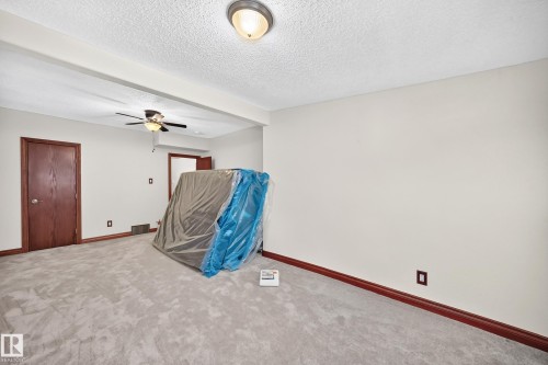 Carpeted room with a ceiling fan, recessed ceiling light, and dark wood-finish trim and doors - 9719 71 Avenue Nw, Edmonton, AB - Indoor Photo Showing Other Room