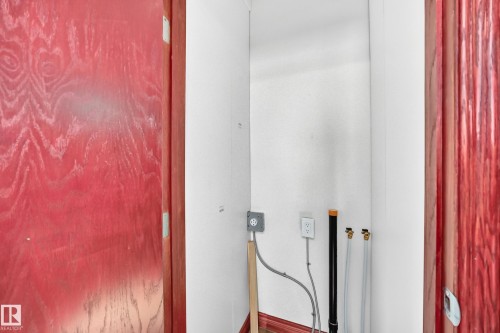 Utility nook featuring white walls and red wood-finish door frames - 9719 71 Avenue Nw, Edmonton, AB - Indoor