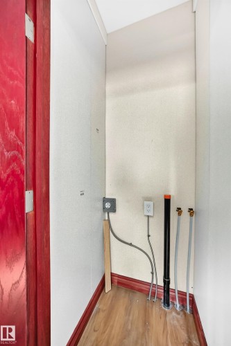 Utility alcove featuring wood-finish flooring and red baseboards - 9719 71 Avenue Nw, Edmonton, AB - Indoor Photo Showing Other Room