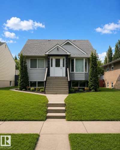 Light grey siding exterior with a contrasting dark stone facade - 9719 71 Avenue Nw, Edmonton, AB - Outdoor With Facade