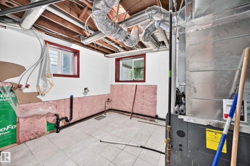 Basement utility area featuring exposed wood joists, white painted walls, and light-toned floor tiling - 9719 71 Avenue Nw, Edmonton, AB - Indoor Photo Showing Basement