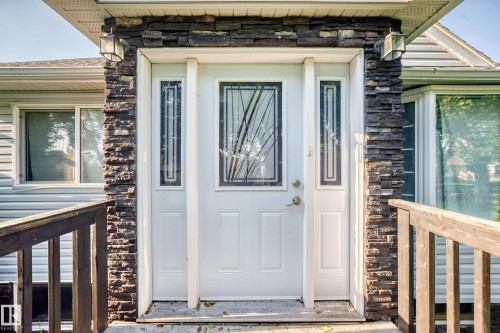 Entry door featuring decorative glass inserts and sidelights - 9719 71 Avenue Nw, Edmonton, AB - Outdoor