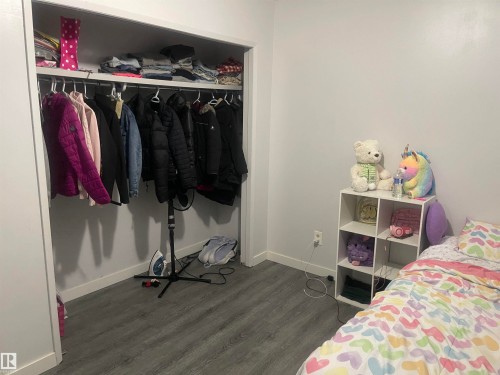 Recessed closet with a hanging rod and upper shelf - 3221 132A Avenue Nw, Edmonton, AB 