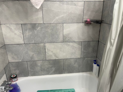 Bathtub with subway tile surround and chrome fixtures - 3221 132A Avenue Nw, Edmonton, AB 