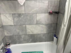 Bathtub with subway tile surround and chrome fixtures - 