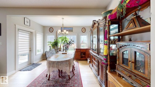 Recessed lighting, wood-finish flooring, and multiple windows with white blinds - 22407 99 Avenue Nw, Edmonton, AB 