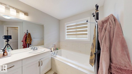 White vanity with integrated sink and chrome fixtures - 22407 99 Avenue Nw, Edmonton, AB 