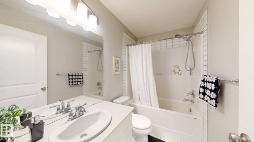 Vanity with dual integrated sinks, chrome faucets, and expansive mirror - 22407 99 Avenue Nw, Edmonton, AB 