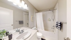 Vanity with dual integrated sinks, chrome faucets, and expansive mirror - 