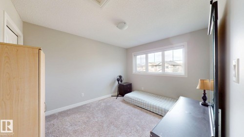 Warm gray wall paint, textured carpet flooring, white trim, and a multi-pane window - 22407 99 Avenue Nw, Edmonton, AB 