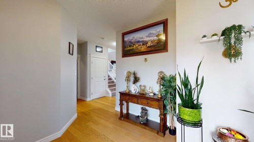 Wood-finish flooring, white painted walls, white trim, and a built-in white shelf - 22407 99 Avenue Nw, Edmonton, AB 
