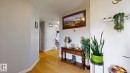 Wood-finish flooring, white painted walls, white trim, and a built-in white shelf - 22407 99 Avenue Nw, Edmonton, AB 