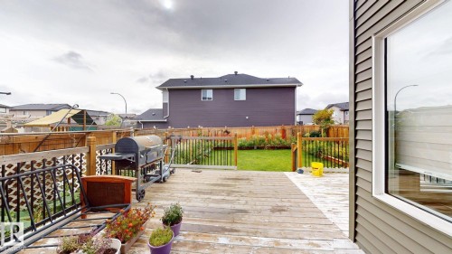 Expansive wood deck with a partial stone paver inlay - 22407 99 Avenue Nw, Edmonton, AB 