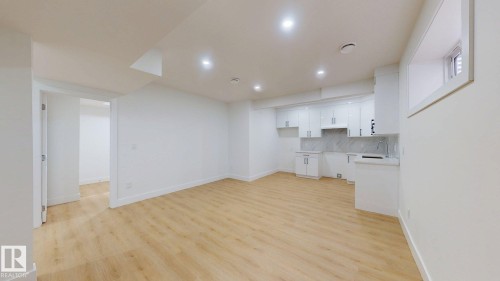 Wood-finish flooring, recessed lighting, white cabinetry, integrated sink, and white countertops - 22407 99 Avenue Nw, Edmonton, AB 