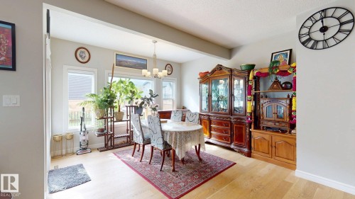 Light-toned wood-finish flooring complements the neutral wall color - 22407 99 Avenue Nw, Edmonton, AB 
