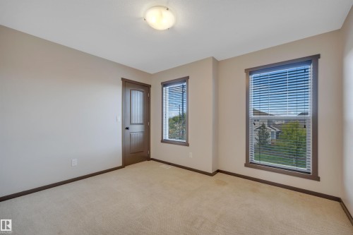 Neutral-toned walls complement the light-colored carpeting - 12903 205 Street Nw, Edmonton, AB 