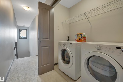 Laundry area featuring a wire storage shelf and light-colored flooring - 12903 205 Street Nw, Edmonton, AB 