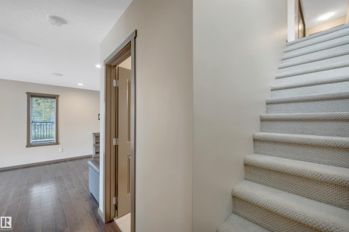 Carpeted staircase, wood-finish flooring, recessed lighting, and a window with blinds - 12903 205 Street Nw, Edmonton, AB 