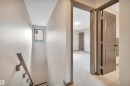 Carpeted hallway with painted trim and doors - 12903 205 Street Nw, Edmonton, AB 