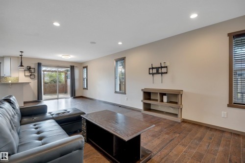Wood-finish flooring throughout, recessed ceiling lighting, and multiple windows with blinds - 12903 205 Street Nw, Edmonton, AB 
