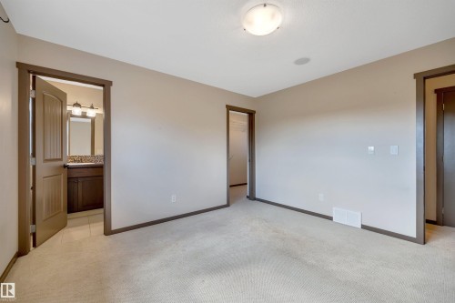 Neutral-toned carpeting, recessed ceiling speaker, and flush-mount ceiling light fixture - 12903 205 Street Nw, Edmonton, AB 