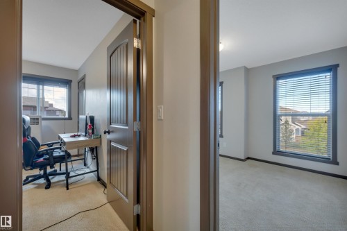 Neutral wall paint, carpeted flooring, and dark trim details - 12903 205 Street Nw, Edmonton, AB 