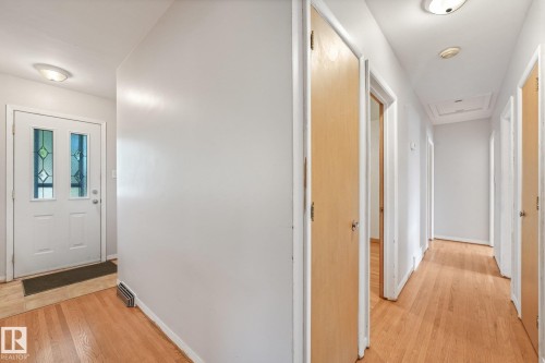 Hardwood flooring throughout, white walls, and flush mount lighting - 11507 135 Street Nw, Edmonton, AB 