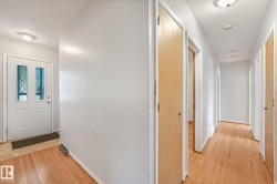 Hardwood flooring throughout, white walls, and flush mount lighting - 