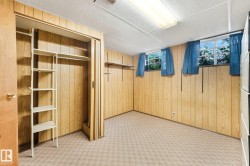 Carpeted flooring, paneled walls, and a drop ceiling - 