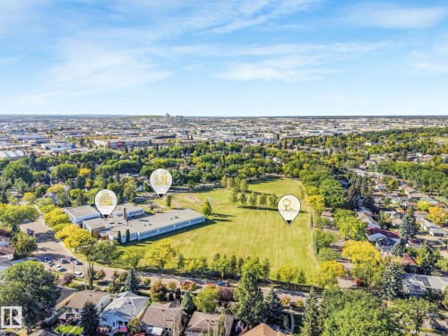 Expansive green space bordered by mature trees and residential properties - 11507 135 Street Nw, Edmonton, AB 