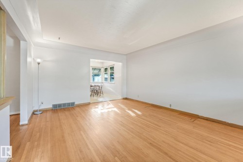 Hardwood flooring, painted white walls, and a recessed ceiling detail - 11507 135 Street Nw, Edmonton, AB 
