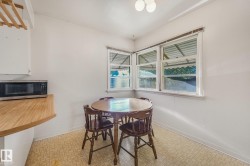 Kitchenette featuring corner window placement, a wood-finish countertop, and patterned flooring - 