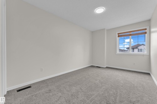 Neutral wall paint, gray carpet flooring, recessed ceiling light, and a window with blinds - 2912 31 Street Nw, Edmonton, AB 