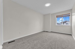 Neutral wall paint, gray carpet flooring, recessed ceiling light, and a window with blinds - 