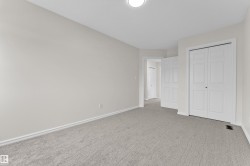 Neutral wall color, light gray carpeting, white trim, and white bi-fold closet doors - 