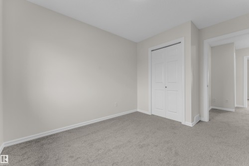 Light gray wall paint, gray carpeting, and white trim - 2912 31 Street Nw, Edmonton, AB 