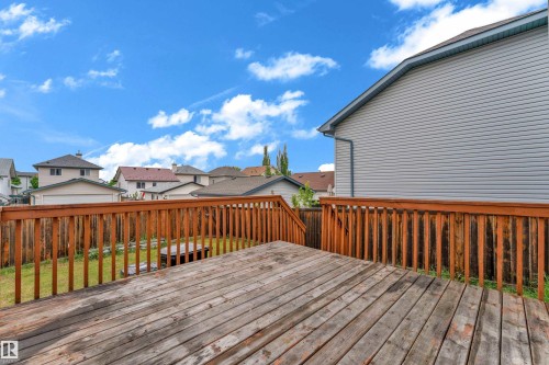 Wooden deck with steps, wood railing, and a fenced backyard - 2912 31 Street Nw, Edmonton, AB 
