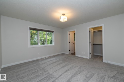 Neutral paint palette, recessed lighting fixture, large window, soft carpeting, and an integrated closet system - 53/55 Michigan Street, Devon, AB 