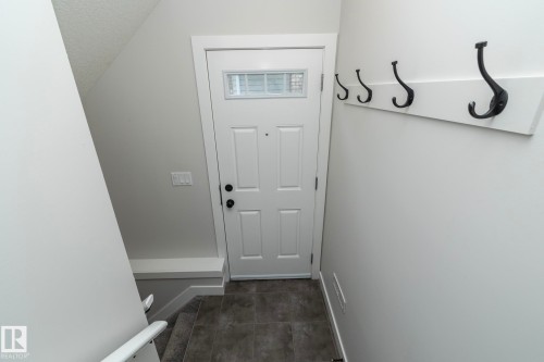 White paneled door with transom window - 53/55 Michigan Street, Devon, AB 