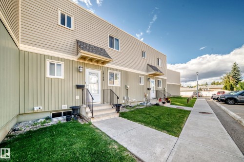 Two-story exterior with two-tone siding, individual entryways, and concrete walkways - 18146 81 Avenue Nw, Edmonton, AB 