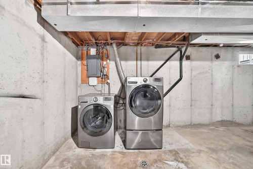 Basement laundry area with concrete walls and flooring - 18146 81 Avenue Nw, Edmonton, AB 