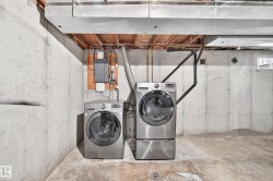 Basement laundry area with concrete walls and flooring - 