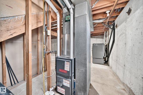 Unfinished basement area with exposed wood framing, concrete flooring, and exposed ceiling joists - 18146 81 Avenue Nw, Edmonton, AB 