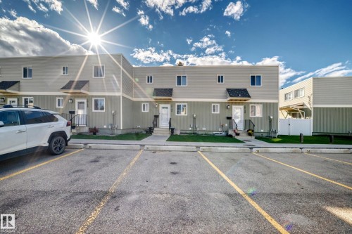 Two-story townhome with light siding and dark trim - 18146 81 Avenue Nw, Edmonton, AB 